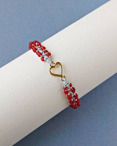 Red Seed Bead Heart Bracelet, Valentines Day Bracelet, Tiny Macrame Bracelet, Gift For Her The Bracelet is made by me with seed beads in red color, gold tone metal heart and light grey synthetic satin cord. ❥It is perfect as a gift to a friend or someone you love. SIZES: --------- Metal heart: 15 mm x 9 mm Width of Bracelet: 6 mm Synthetic Satin Cord: 0.9 mm Seed Beads: 2 mm Adjustable size in length with a sliding spiral macrame knot. Expands from 15 to 26 cm. Let me know if you need a differen Tiny Macrame, Seed Bead Heart, Valentines Day Bracelet, Spiral Macrame, Adjustable Beaded Bracelet, Bracelet Valentines, Bead Heart, Bracelet Friendship, Macrame Knot