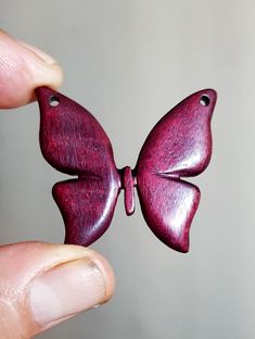 a person holding a purple butterfly shaped object