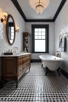 an old fashioned bathroom with black and white tile flooring, tub, sink and mirror