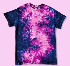 a purple and blue tie - dyed t - shirt on a pink background