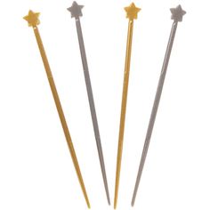 three gold and silver stars are on top of two metal needles, one is pointed at the other