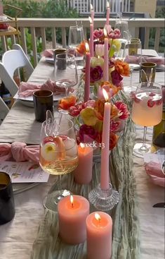 the table is set with candles and wine glasses