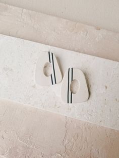 two white and black ceramic objects on a wall