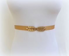 "This classic elastic waist belt with a gold grecian leaf clasp is the perfect finishing touch to upgrade every outfit. You can wear it on a dress, skirt, jumpsuit, pants or tunic. Comfortable and flattering to a woman's waistline. ❤ Sizes: XS Fits waists 25\"- 27\" (63- 68cm) Length end to end 24\" (60cm) S Fits waists 27\"- 29\" (68- 73cm) Length end to end 26\" (65cm) M Fits waists 29\"- 31\" (73- 78cm) Length end to end 28\" (70cm) L Fits waists 31\"- 33\" (78- 83cm) Length end to end 30\" ( Gold Fitted Belt, Elegant Gold Corset Belt For Parties, Chic Gold Belt For Summer, Gold Fitted Belt For Formal Occasions, Elegant Rope Belt For Spring, Formal Fitted Gold Belt, Gold Adjustable Belt For Spring, Gold Belt For Party Occasions In Spring, Adjustable Elegant Corset Belt