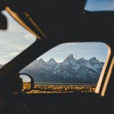 the view from inside a car looking at mountains