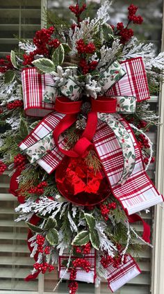 a christmas wreath hanging on the front door