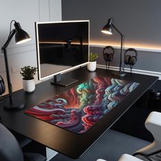 a desk with a computer monitor and headphones on it