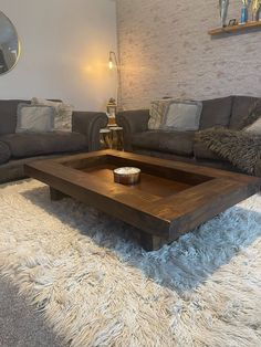 a living room with two couches, a coffee table and a rug on the floor