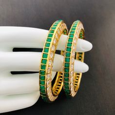 Traditional Bollywood bangles pair of 2 bangles with American diamond, emerald, ruby and semi-precious Stones work. This bangles set is handcrafted with love and creativity and are perfect for any occasion may it be engagement, Wedding or any bridal ceremonies or social get-together. These handcrafted beautiful high quality bangles are made in brass alloy metal with traditional Jadau handwork and are lined with fine lustrous stones. Pair them up with Indian traditional outfit such as Anarkalis, Fusion Style Stackable Bangle Jewelry, Elegant Stackable Bangle For Festivals, Designer Bangle With Single Cut Diamonds, Green Bangle For Formal Occasions, Fine Jewelry Style, Green Bangle For Formal Festivals, Designer Single Cut Diamond Bangle, Green Bangle For Formal Events And Festivals, Designer Green Bracelets For Gifts, Designer Green Bracelets As Gift