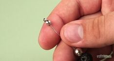 a person holding a tiny bead in their left hand