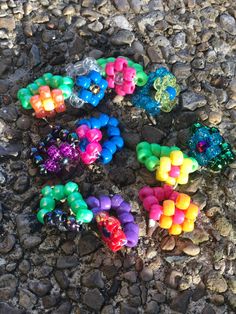 there are many beads that are on the ground next to some rocks and stones,