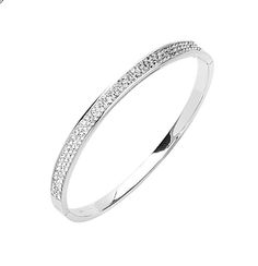 Strike sparkle and shine on wearing this glamorous Two Row Simulated Diamond CZ Oval Bangle Bracelet in Sterling Silver. It is beautifully crafted in sterling silver and is ideal to build an elegant look on when worn either standalone or as a stack piece around your wrist. This bangle bracelet is hypoallergenic and nickel free in nature. It is also well secured by a box clasp that offers safety and comfort when worn. The bangle is extremely elegant as it is only 3mm thick and 7.5 inches in circu Oval Bangle, Crochet Mat, Box Clasp, Shine On, In Nature, Bangle Bracelet, Diamond Bracelet, Cuff Bracelets, The Row