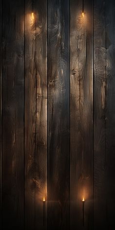 a wooden wall with some candles lit up in the dark and one light is on