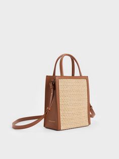 Made for breezy summer days, this raffia tote bag is the perfect companion during the warmer months. The texturally rich body and lovely brown trim will put the perfect finishing touch on any warm-weather ensemble. Opening up to a spacious interior, it will be able to hold everything you need in a day with ease - the magnetic closure keeps your belongings secure and accessible. Raffia Tote Bag, Brown Trim, Size Chart For Kids, Charles Keith, Printables Kids, Belt Size, Magnetic Closure, Summer Days, Warm Weather