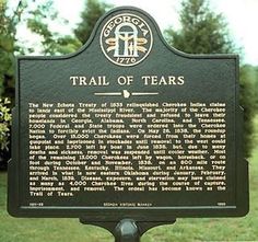 the trail of tears marker in front of some trees