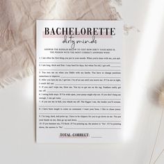 a piece of paper with the words bachelor list on it next to some dried flowers