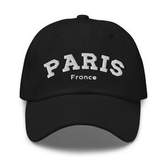 a black hat with the word paris in white on it, against a white background