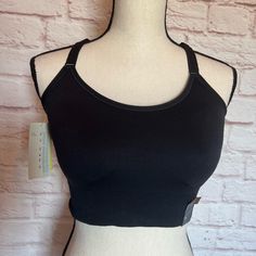 Brand New With Tags And Never Worn. Black Cami Sports Bra With Removable Cups And Halter Back. It Offers Medium Support And Moisture Wicking Material. Size Is A Xxl. Black Supportive Tops With Built-in Bra, Supportive Black Tops With Built-in Bra, Black Stretch Camisole With Built-in Bra, Black Camisole With Built-in Bra And Wide Straps, Supportive Black Top With Built-in Bra, Black Camisole Sports Bra For Workout, Light Support Sleeveless Fitted Bra, Black Camisole With Built-in Bra For Yoga, Fitted Bra With Removable Pads For Relaxation