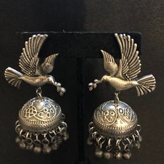 Oxidized Silver bird Jhumka earrings/Silver Jhumka Earrings/Silver Oxidized Earrings/Indian Jhumka Earrings/ Indian Jewelry - Earrings Length: 2.5 Inches - Comes with push back closure - Lightweight Earrings - Silver Oxidized Earrings with simulated stones in silver finish. - Very Elegant and stylish, these Earrings can be paired with any Attire depending upon the occasion and the theme. - The base is pure brass (90%) and pure 92.5 silver (10%) which makes this very sturdy and of good quality. - Silver Danglers With Latkans For Festivals, Silver Jhumkas For Celebration Festivals, Silver Jhumkas With Latkans For Diwali, Silver Jhumkas With Latkans For Navratri, Silver Temple Jewelry Jhumkas For Festivals, Silver Drop Jhumkas For Festivals, Traditional Silver Jhumkas For Navratri, Silver Drop Earrings Jhumkas For Festivals, Silver Jhumkas Drop Earrings For Festivals