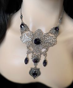 "This elegantly ornate necklace is made with light weight, antique silver tone filigrees and pendants, featuring romantic scrolls and beautifully balanced details. Its mesmerizing design is accented with dazzling deep violet purple glass crystals/jewels. Decorated portion is 6 1/2\" wide and 4 3/4\" tall in the very center. Necklace length is adjustable 15\"-18\" with soldered stainless steel cable chain, lobster clasp and extender. If you would like a different length, please send us a message. Gothic Antique, Ornate Necklace, Purple Gothic, Dark Amethyst, Victorian Wedding, Choker Pendant, Stainless Steel Cable, Violet Purple, Amethyst Purple