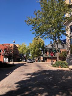 an empty street with cars parked on the side