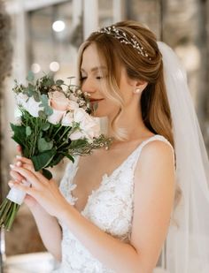 a woman in a wedding dress holding flowers