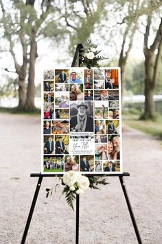 an easel with pictures and flowers on it in the middle of a park area