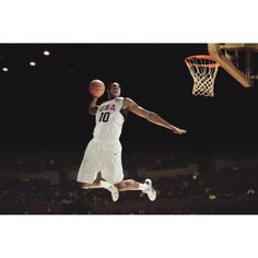 a man jumping up into the air to dunk a basketball