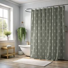 a white bath tub sitting next to a shower curtain in a bathroom under a window