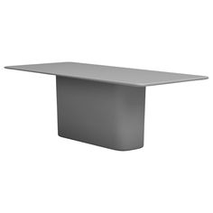 a white table sitting on top of a white floor next to a black and gray wall