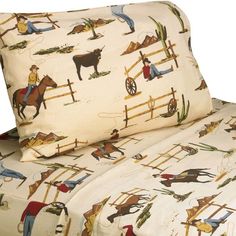 the bed is made with cowboy themed sheets