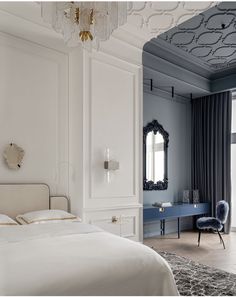 a bedroom with a bed, dresser and chandelier hanging from it's ceiling