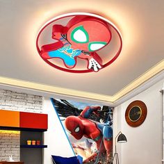 a bedroom with a spiderman mural on the wall