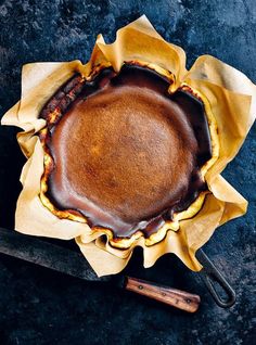 a chocolate pie sitting on top of a table next to a pair of utensils