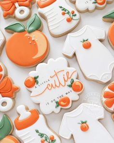 decorated cookies with orange and white designs on them