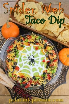 a spider web taco dip is on the table