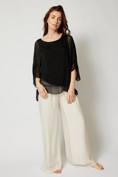 This silk top from Italy has a lovely ruffle on the arm and the bottom of the top. The flowing silk gives it an effortless and feminine look. The sleeves flatter your arms and pair perfectly with our Italian Silk Pants or leggings! Available in Black, Ivory, Taupe, and Rose Built-in shell lining - you don't need a cami Designed and made in Italy Material: Washable Silk One size fits most Thousand Oaks, Silk Pants, Feminine Look, Simply Beautiful, Silk Top, Ruffle Trim, Print Tops, Womens Clothing Tops, Blouses For Women