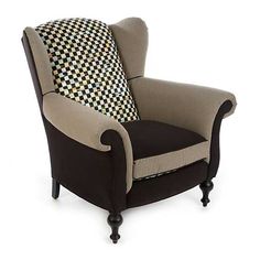 a black and white chair with a checkered pillow on it