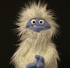 a close up of a stuffed animal on a black background