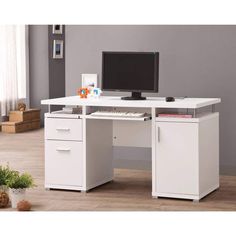 a white computer desk with two drawers and a monitor on the top, in front of a gray wall