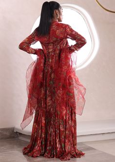 Printed palazzo with matching jacket and embroidered top. Red Party Sets For Fall, Fitted Festive Sets For Fall, Festive Fitted Sets For Fall, Fall Wedding Sets With Floral Embroidery, Fall Wedding Floral Embroidered Sets, Fall Wedding Floral Embroidery Sets, Silk Red Sets With Floral Print, Red Silk Sets With Floral Print, Fitted Anarkali Palazzo Set With Long Sleeves