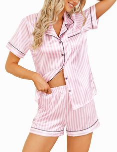 a woman in pink and white striped pajamas with her hand on her hip, posing for the camera