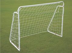 a soccer goal on the ground with grass