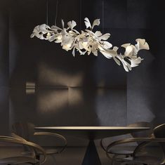 an elegant chandelier hangs from the ceiling over a round dining table with chairs