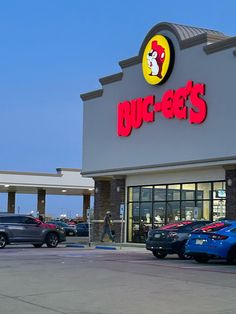 a store front with cars parked in the lot