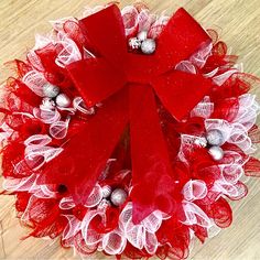 a red and white christmas wreath with bells