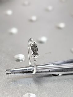 a diamond ring sitting on top of a pen