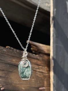 This beautiful silver pendant features a polished Moss Agate Crystal! The pendant was handcrafted by Holly from Tumbled Shop using sterling silver plated wire. Moss Agate speeds up recovery from any illnesses. Moss Agate puts up shields offering you and your aura protection. This protection allows you to feel safe to be the true version of you! It makes you realize that there is happiness and joy all around us through life, friends, family and animals! This comfort allows us to go back to our ro Wire Wrapped Ocean Jasper Pendant Necklaces, Ocean Jasper Wire Wrapped Pendant Necklaces, Wire Wrapped Ocean Jasper Pendant Jewelry, Wire Wrapped Ocean Jasper Pendant Necklace, Handmade Silver Moss Agate Jewelry, Silver Moss Agate Jewelry Gift, Silver Wire Wrapped Moss Agate Necklace, Silver Moss Agate Jewelry As A Gift, Silver Moss Agate Jewelry For Gift