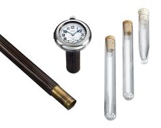 an assortment of different items including a clock and two tubes