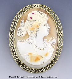 Presented is a Victorian, 10 karat yellow gold and hand carved shell cameo brooch/pin or pendant from the late 1800s or very early 1900s. The solid gold mounting is done in a wonderful, openwork design, like brickwork or something similarly geometric. The bezel set cameo is carved into the form of a lovely young woman in a 19th century style, very detailed and well done, with two tiny red stones set in her hair ornament. There is a hinged bale or loop on the top to hang the piece as a pendant. T Moss Agate Ring, Cameo Jewelry, Vintage Cameo, Carved Shell, Cameo Brooch, Pin Pendant, Gold Top, Brooch Jewelry, Warhammer Fantasy